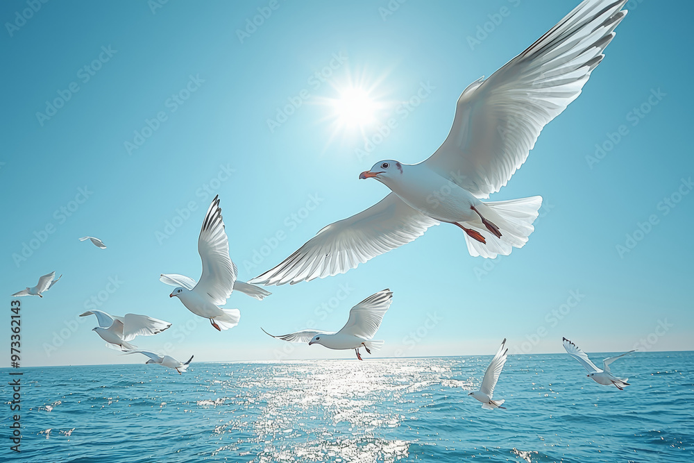 Obraz premium A flock of birds flying in a synchronized pattern across a clear blue sky. Concept of harmony and peaceful movement.