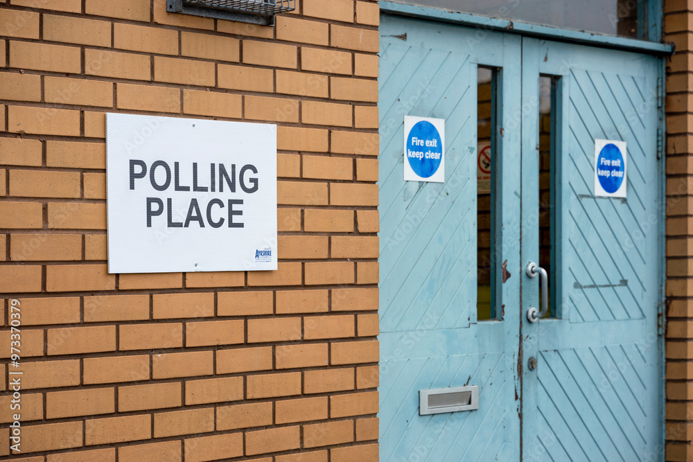 Obraz premium Democracy Election Voting Polling Place white sign on wall beside door entrance to polling station community centre
