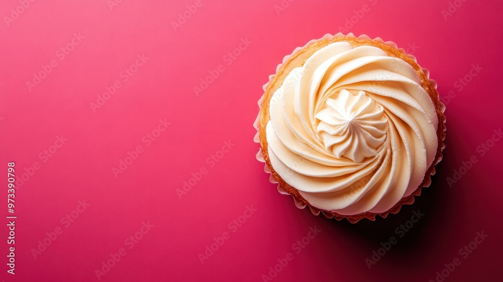 A beautifully decorated cupcake with swirls of creamy frosting on a vibrant pink background. The cupcake is presented from above, showcasing its intricate design and texture A beautifully decorated cupcake with swirls of creamy frosting on a vibrant pink background. The cupcake is presented from above, showcasing its intricate design and texture
