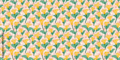 seamless pattern of bright yellow calalilies with mint green leaves on a blush pink heart-patterned background photo