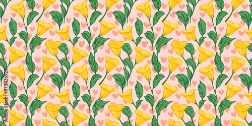 seamless pattern of bright yellow calalilies with mint green leaves on a blush pink heart-patterned background photo