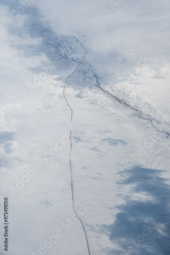 Single road through a barren snowy landscape, only one path forward