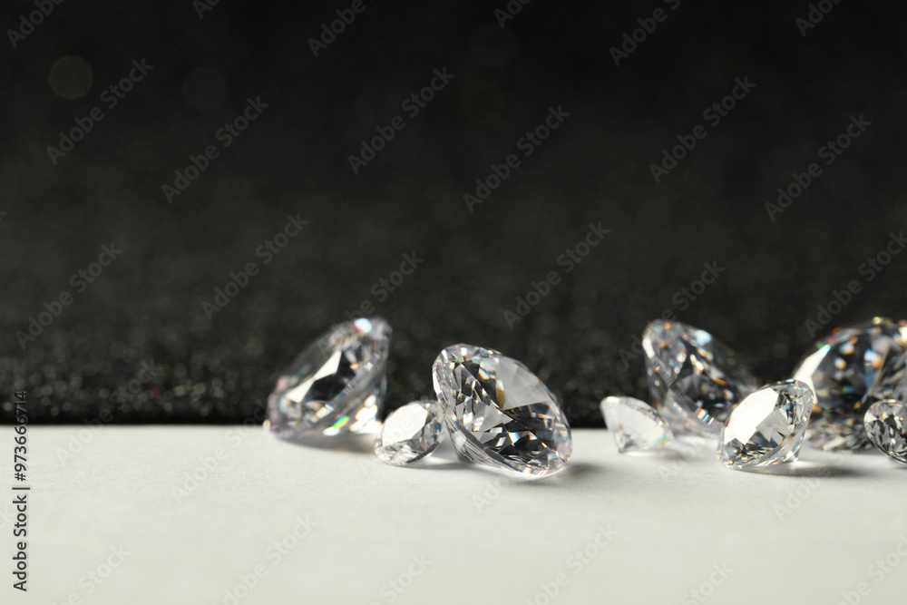 Beautiful dazzling diamonds on light grey table, closeup Beautiful dazzling diamonds on light grey table, closeup