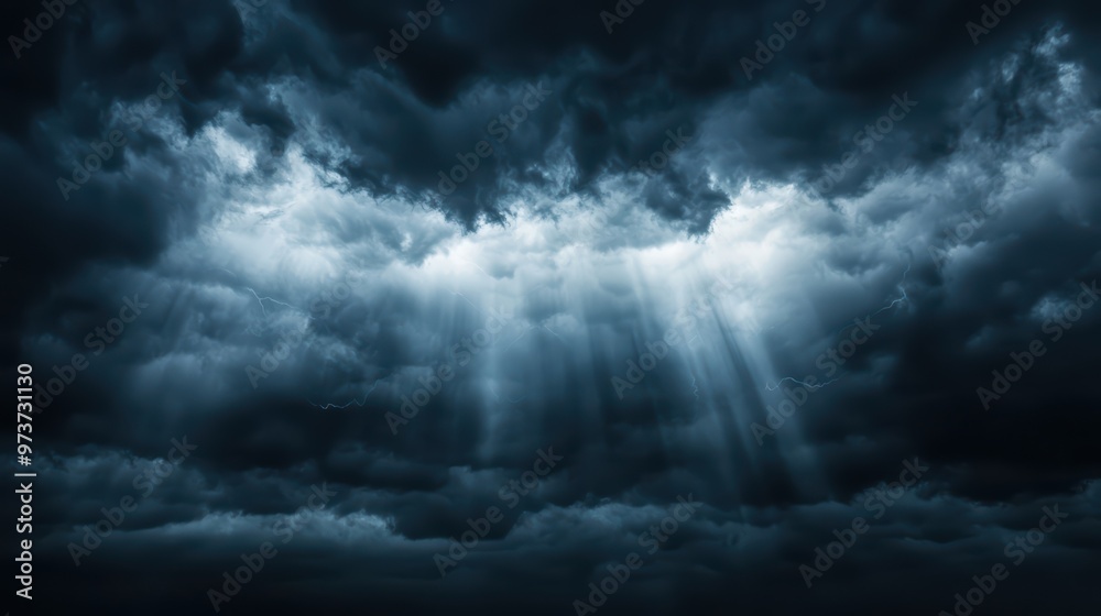 Dramatic Stormy Sky with Sun Rays Breaking Through Dark Clouds in a Moody Atmosphere Dramatic Stormy Sky with Sun Rays Breaking Through Dark Clouds in a Moody Atmosphere