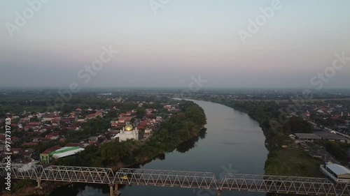 Panoramic aerial video of the Karanggeneng Bridge over the Bengawan Solo River in the afternoon.