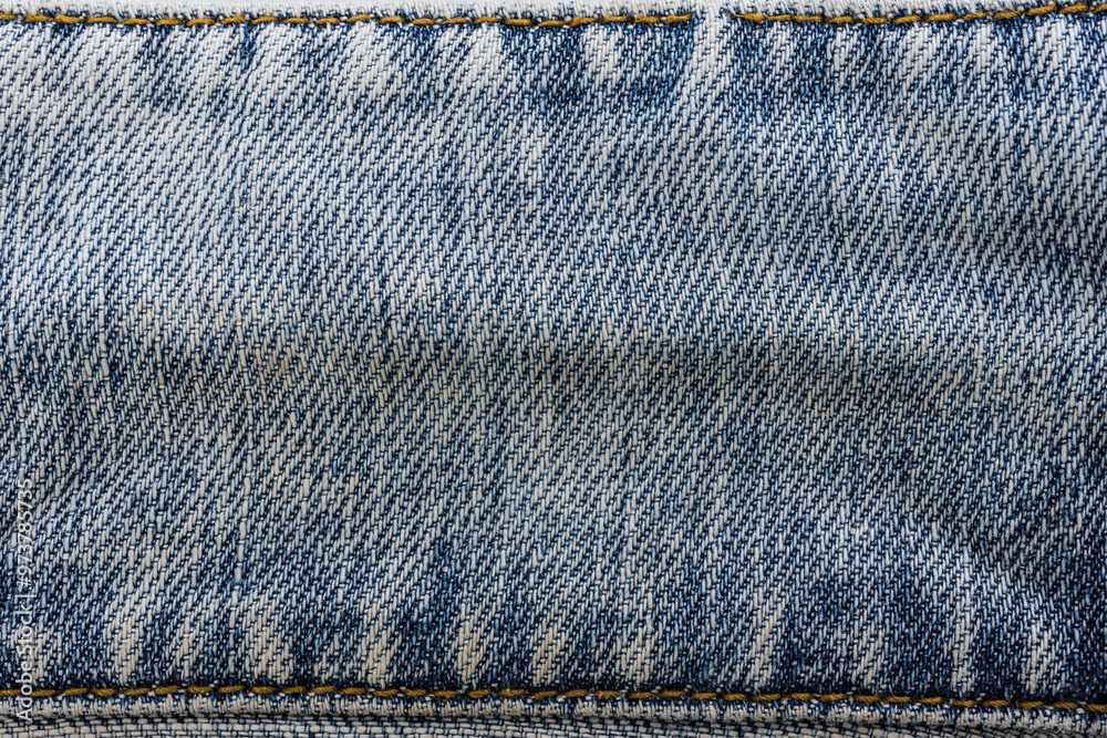 An image of close-up blue denim jeans fabric showing detailed texture with a dark blue color and a stylish design backdrop An image of close-up blue denim jeans fabric showing detailed texture with a dark blue color and a stylish design backdrop