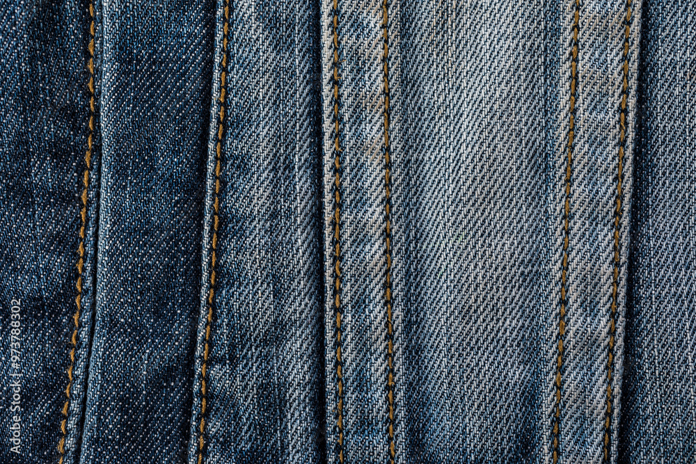 Close-up of blue denim jeans texture with visible pocket and seam Close-up of blue denim jeans texture with visible pocket and seam