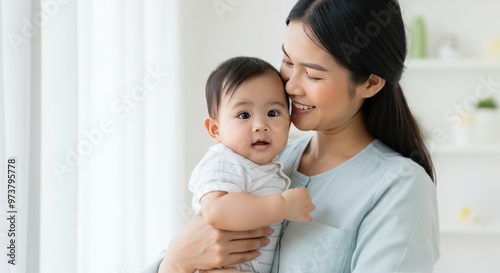 Mother Holding and Looking at Her Baby