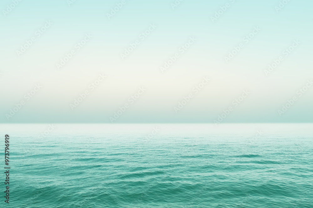 Calm ocean water surface merging with pastel sky on horizon Calm ocean water surface merging with pastel sky on horizon