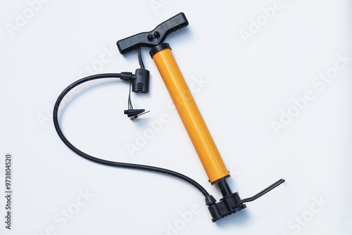 Yellow and black bicycle pump isolated against a white background.
