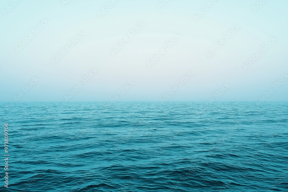 Obraz premium Vast blue ocean merging with the foggy sky