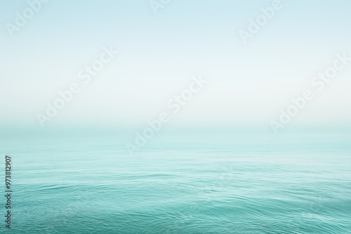 Calm ocean water merging with pastel sky on horizon line