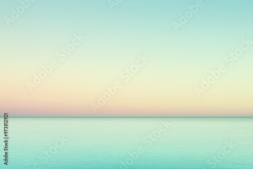 Calm ocean reflecting pastel colors of sunset sky