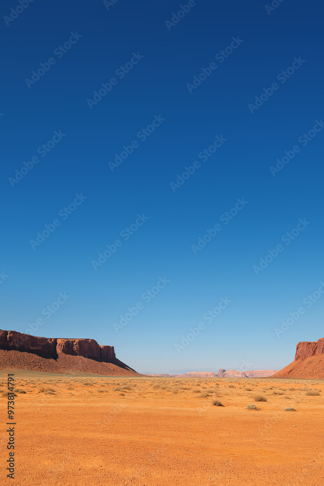 Monument valley landscape showing red sand and blue sky Monument valley landscape showing red sand and blue sky