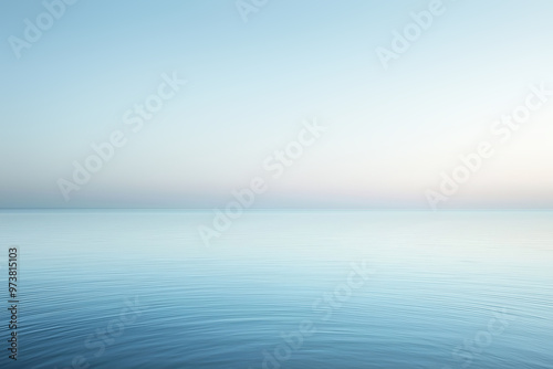 Calm ocean water reflecting pastel colors of sunset sky