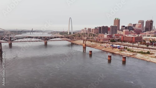 Aerial video over the Mississippi River looking into a view of downtown Saint Louis, Missouri city on a clear sky day with bridges and skyscrapers. photo