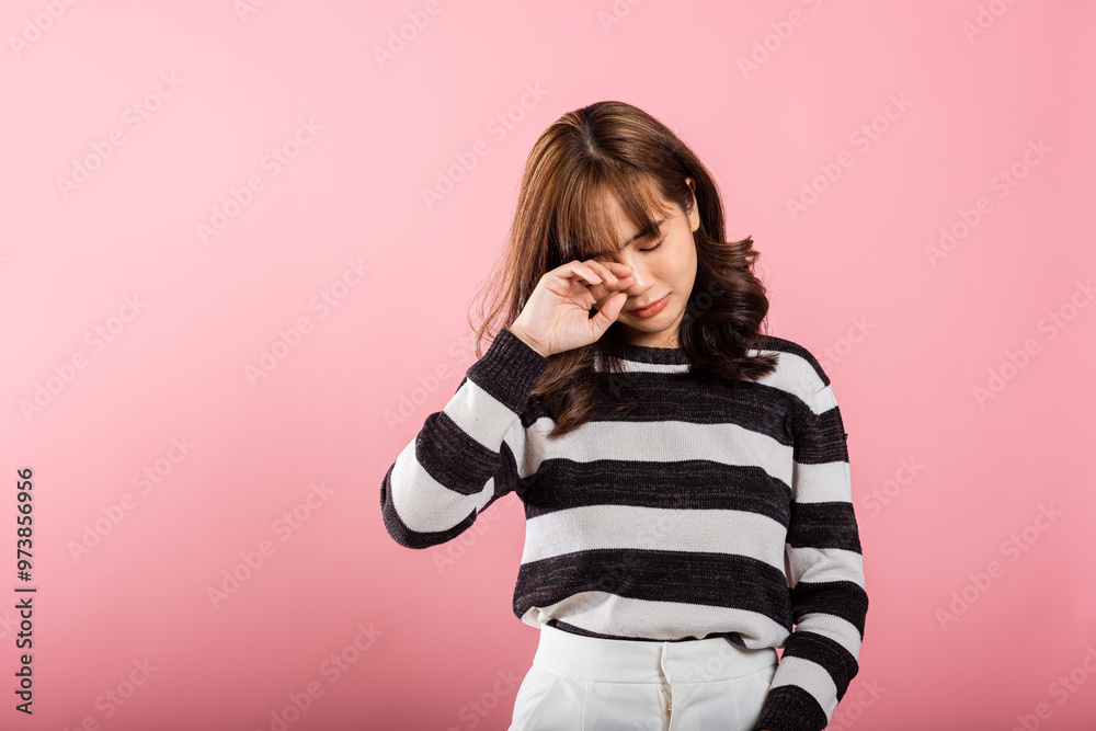 Female feeling sad unhappy crying frowns face doleful desperate, studio shot isolated on pink background, Asian beautiful young woman bad mood her cry wipe tears with fingers, Negative emotion Female feeling sad unhappy crying frowns face doleful desperate, studio shot isolated on pink background, Asian beautiful young woman bad mood her cry wipe tears with fingers, Negative emotion