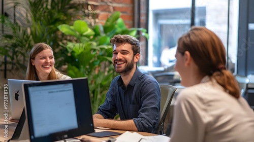 Three Smiling Coworkers Collaborating in Modern Office