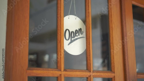 Open sign hanging on the door glass at the coffee shop. Open sign board at the cafe, coffee shop, hotel, cafe restaurant or retail store