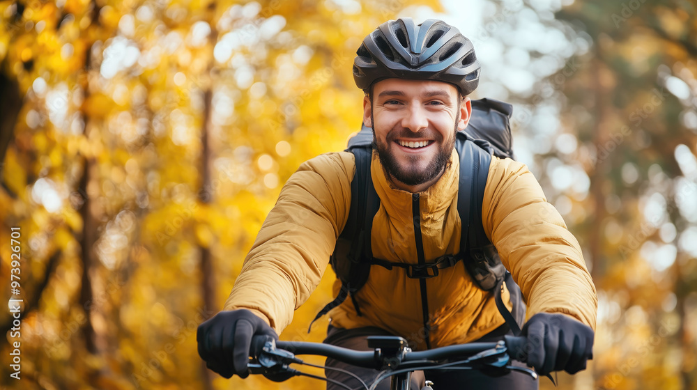 Smiling man riding a bicycle in autumn forest Smiling man riding a bicycle in autumn forest