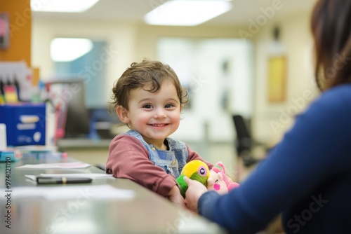 At the doctors office, parents check in while their child clutches a favorite toy, creating a welcoming and child-friendly atmosphere. photo