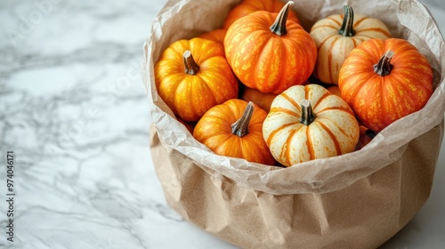 Miniature pumpkins bringing autumn colors into a brown paper bag