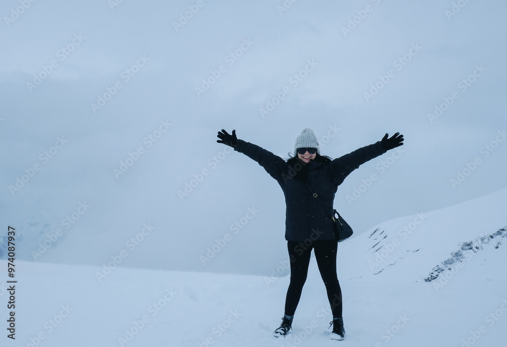 Grindelwald first, Switzerland Woman on First Cliff Walk viewing platform on the First mountain in Grindelwald with Alpine views. Grindelwald first, Switzerland Woman on First Cliff Walk viewing platform on the First mountain in Grindelwald with Alpine views.
