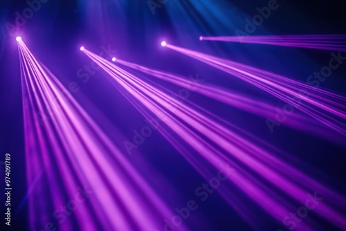 Blue and violet beams of bright laser light shining on black background