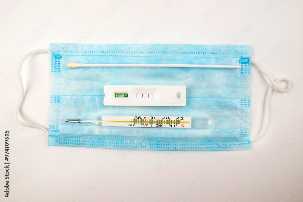 Covid positive test on blue medical face mask background, Covid-19 negative, result antigen test kit (ATK), prevent virus infection, Disposable surgical, air Covid positive test on blue medical face mask background, Covid-19 negative, result antigen test kit (ATK), prevent virus infection, Disposable surgical, air