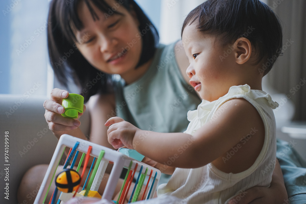 Asian woman playing with her child in the living room
Asian woman playing with her child in the living room