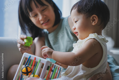 Asian woman playing with her child in the living room
 photo