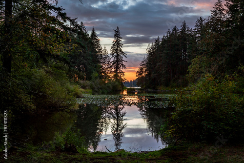 Beautiful dramatic sky and sunset reflection in calm water of The Lacamas Lake in Washington State 
