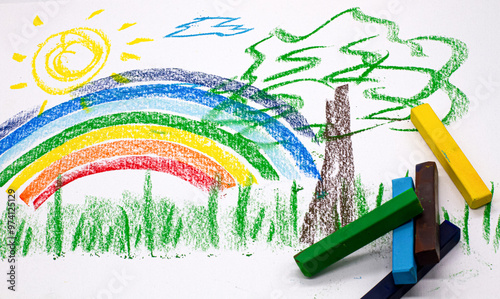 crayons on the background of a drawing with a rainbow and a tree to decorate children's design themes for the background photo