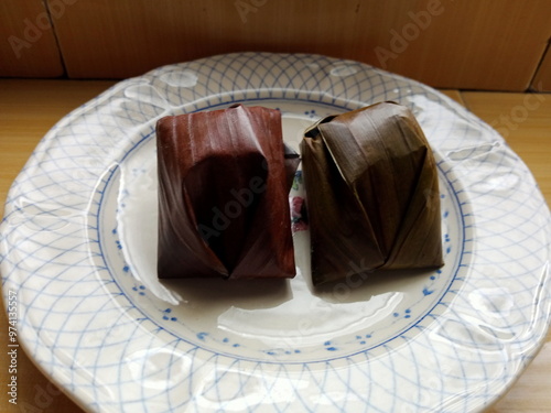 passover cake,  dessert made from glutinous rice wrapped in banana leaf. photo taken in malaysia. southeast asian desert aka kue  kochi photo
