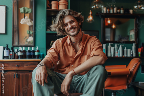 Smiling customer sitting in barber shop. Happy business owner in his hair salon. SME, entrepreneur