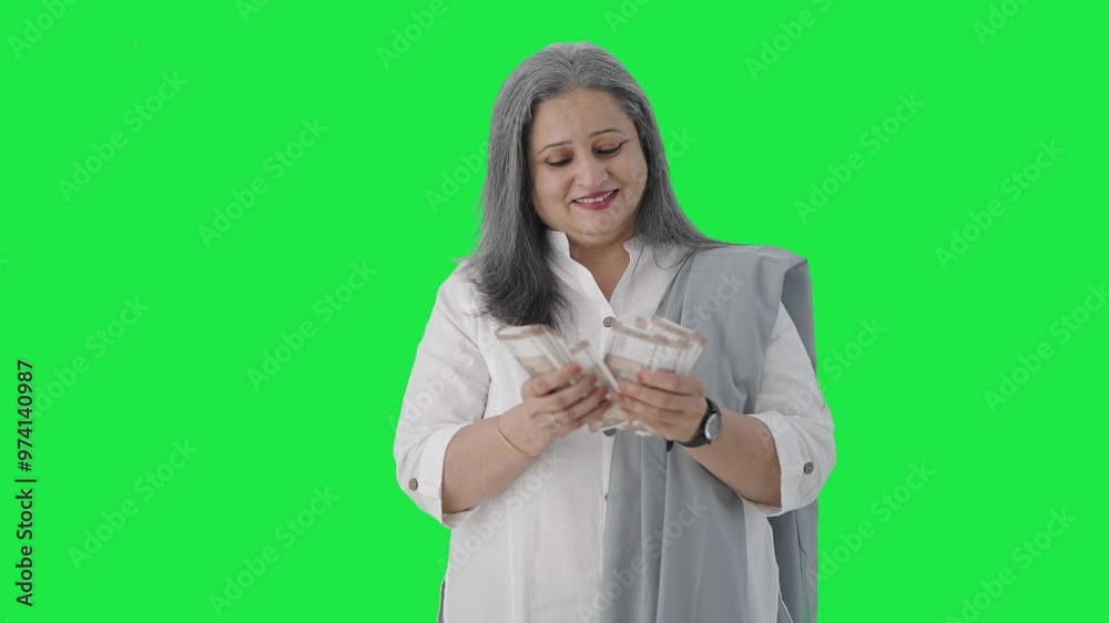 Happy Indian senior businesswoman counting money Green screen Happy Indian senior businesswoman counting money Green screen