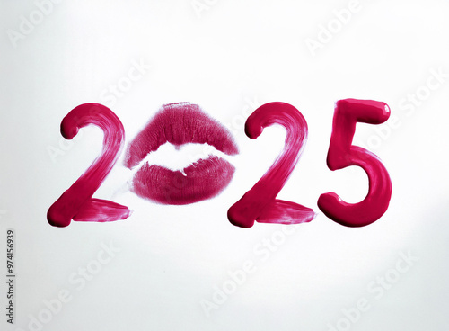 Writing 2025 with red lipstick cream, isolated on white background. Creating a swirl 2025 from red lipstick. Close up red lipstick detail photo isolated on white background