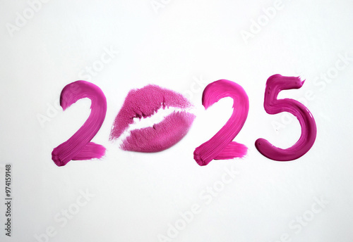 Writing 2025 with pink lipstick cream, isolated on white background. Creating a swirl 2025 from red lipstick. Close up pinklipstick detail photo isolated on white background photo