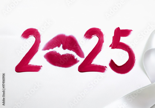 Writing 2025 with red lipstick cream, isolated on white background. Creating a swirl 2025 from red lipstick. Close up red lipstick detail photo isolated on white background