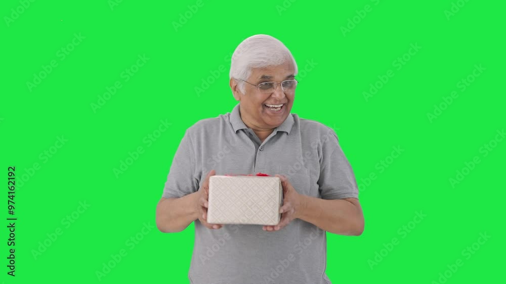 Happy Indian old man receiving a gift Green screen Happy Indian old man receiving a gift Green screen