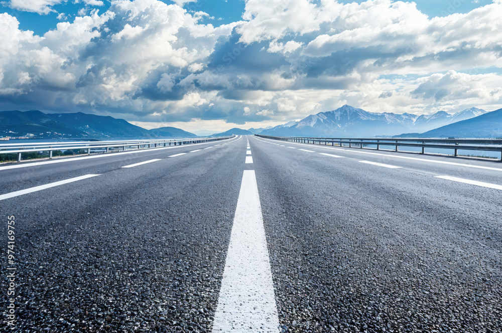 Fototapeta premium Empty highway leading to the mountains on a cloudy day