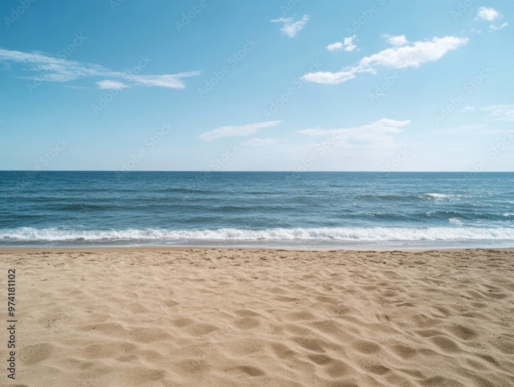 Fototapeta premium An empty beach scene with a calm sea and open sky offers a serene natural backdrop. 