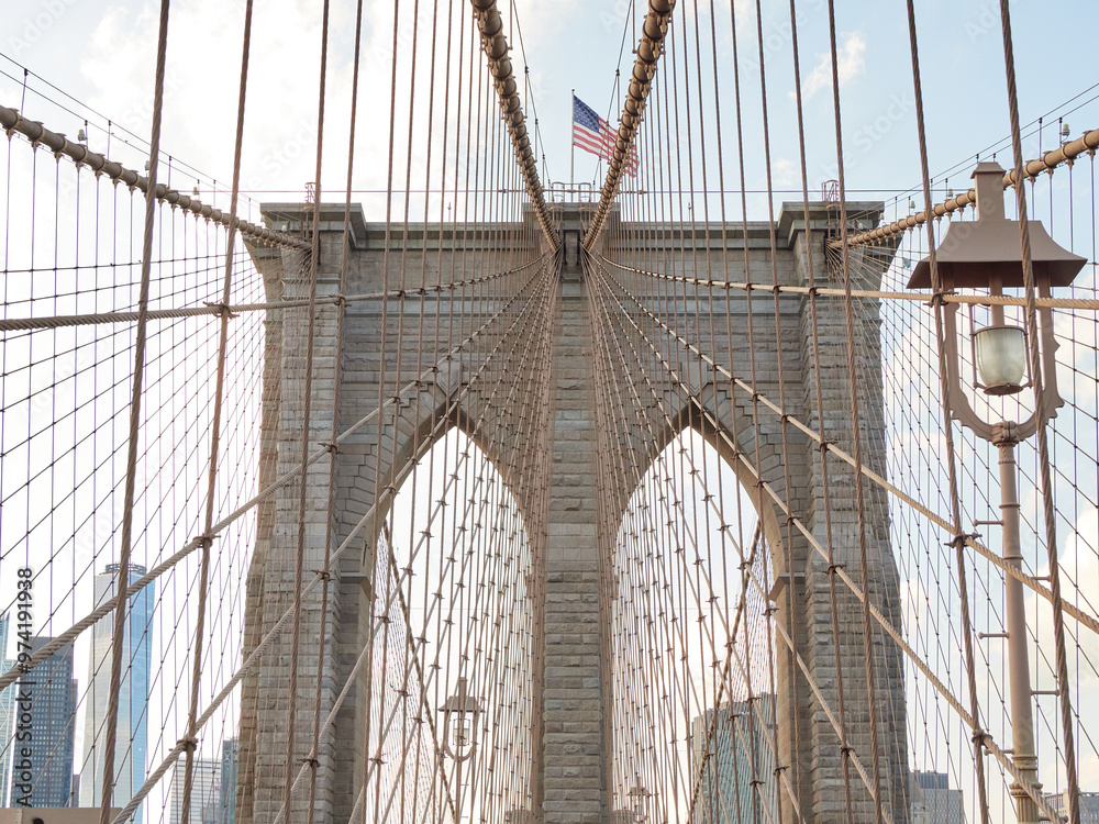 Fototapeta premium Brooklyn Bridge, connects the boroughs of Manhattan and Brooklyn in New York City. It is a historic symbol of New York and a fundamental part of the city, as it crosses the East River connecting Manha