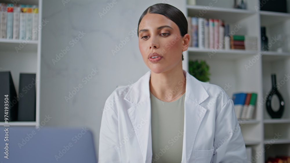 Medicine consultant talking computer camera in clinic closeup. Doctor video call Medicine consultant talking computer camera in clinic closeup. Doctor video call