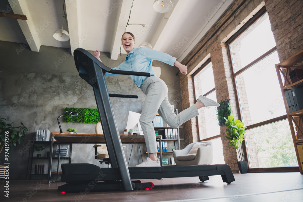 Fototapeta premium Photo of cheerful funny lady recruiter dressed shirt running treadmill indoors workplace workstation loft