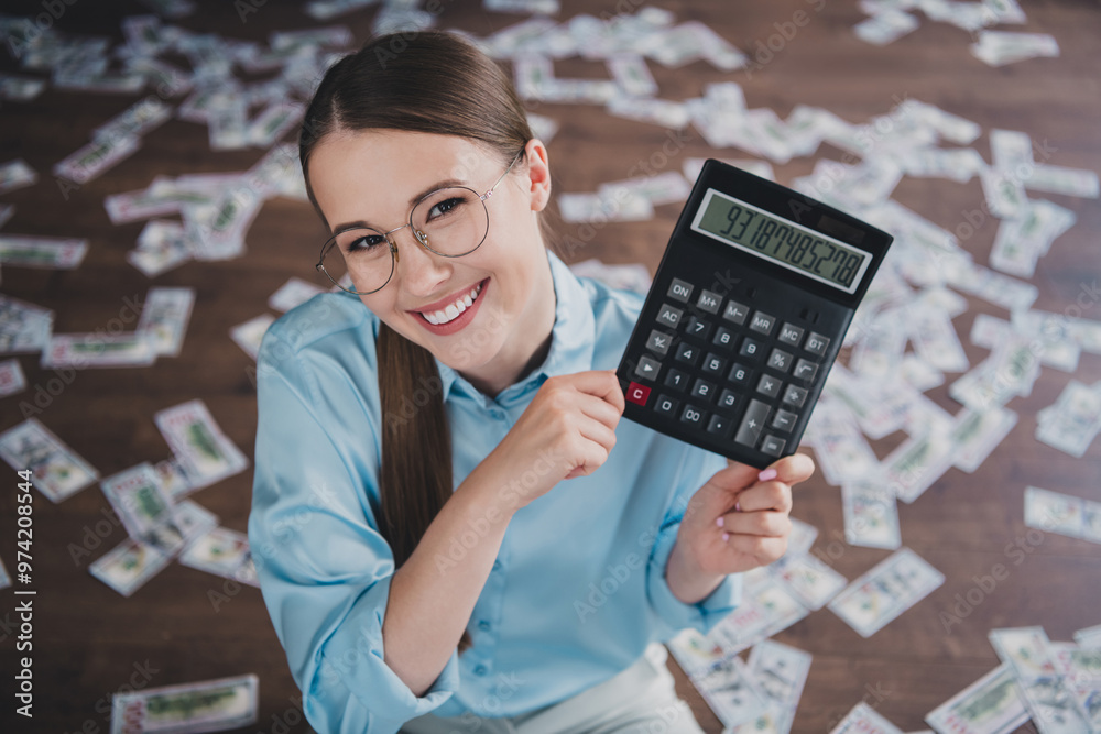 Photo of sweet charming lady assistant wear shirt glasses counting dollars calculator indoors workplace workstation Photo of sweet charming lady assistant wear shirt glasses counting dollars calculator indoors workplace workstation