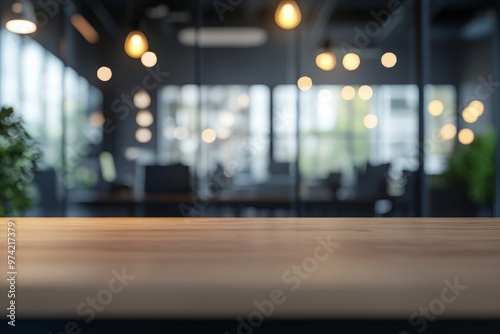 Blurred office background with blurred glass door and window, tabletop for product display in a modern business center interior.