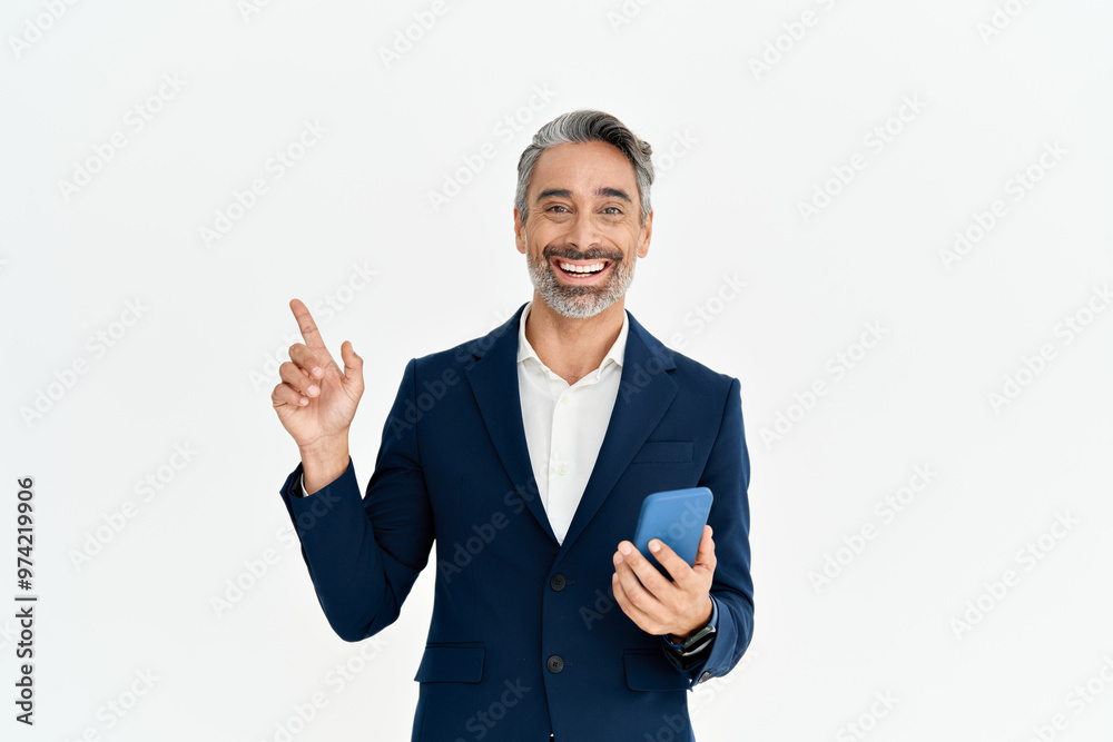Happy business man of middle age holding phone pointing aside presenting ads. Smiling mature professional businessman in suit with smartphone using mobile banking app on cellphone isolated on white. Happy business man of middle age holding phone pointing aside presenting ads. Smiling mature professional businessman in suit with smartphone using mobile banking app on cellphone isolated on white.
