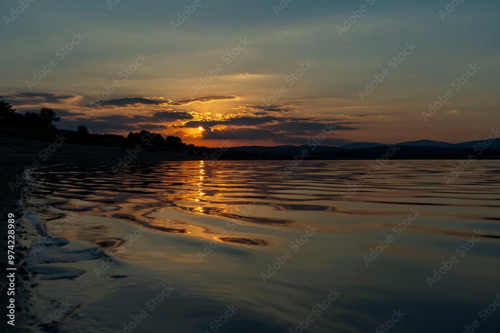 beautiful sunset reflected in the water of the dam beautiful sunset reflected in the water of the dam