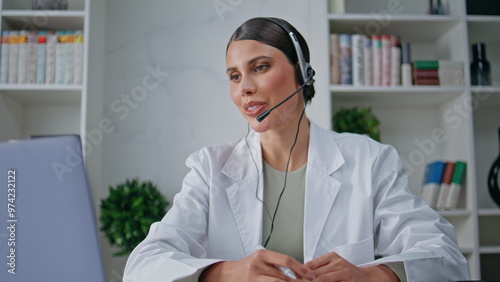фотографія Clinic consultant talking headset providing customer service in clinic closeup